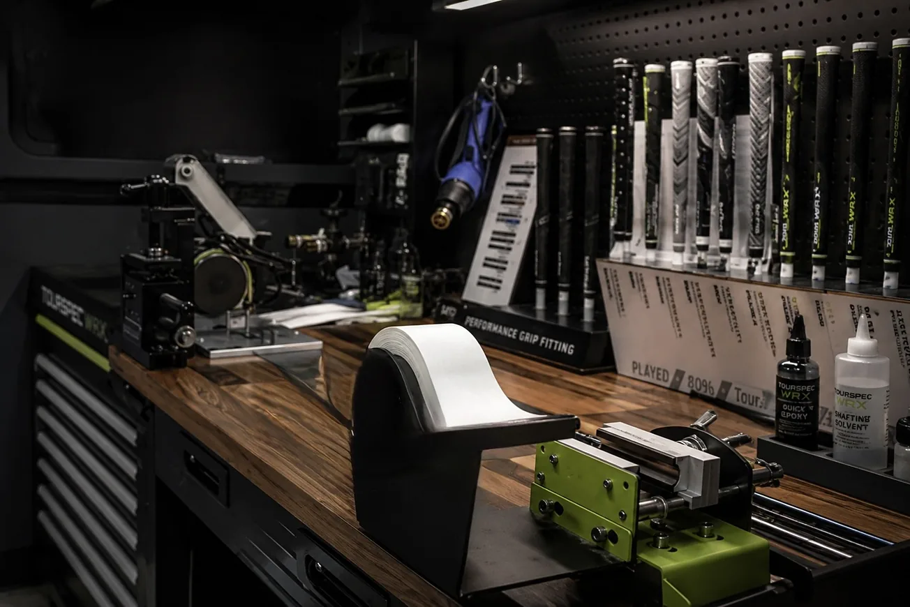 A golf club being repaired on the workbench at TOURSPECWRX